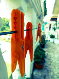 Close-up of clothespins hanging on clothesline