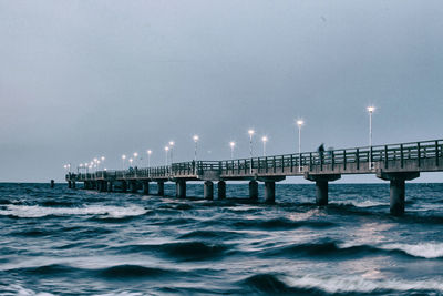 Pier over sea against sky