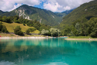 Scenic view of lake by mountains against sky