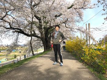 Full length of man standing by tree