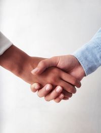 Close-up of hands over white background