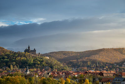 Town by buildings in city against sky