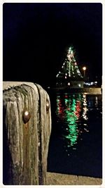 Reflection of illuminated built structure in water