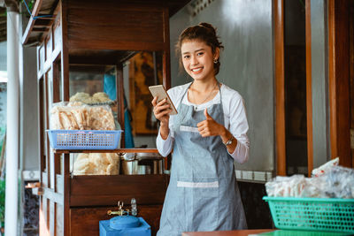 Portrait of young woman using mobile phone