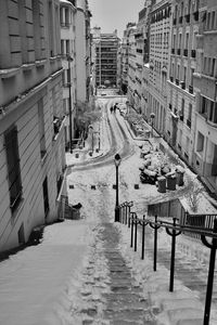 High angle view of street amidst buildings during winter