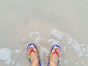 Low section of person standing on beach