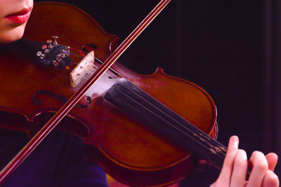 Cropped image of woman playing violin