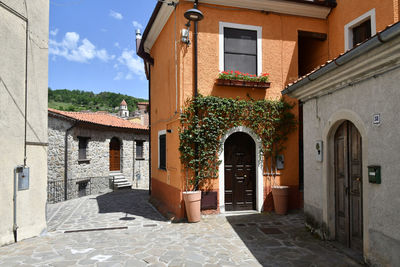 A narrow street between the old houses of sasso di castalda, a village of basilicata region, italy.