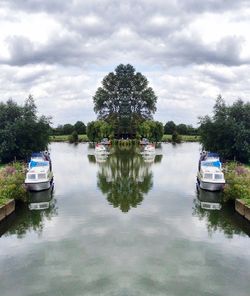 Scenic view of calm lake against cloudy sky