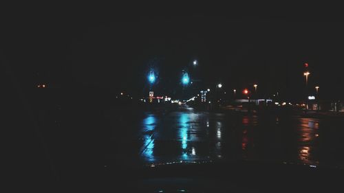 Illuminated city against sky at night