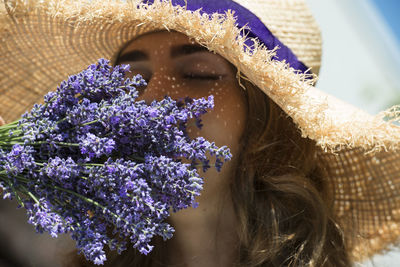 Close up photo of a woman and a lavender bouquet