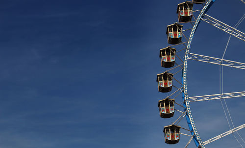 Low angle view of ferris wheel against sky