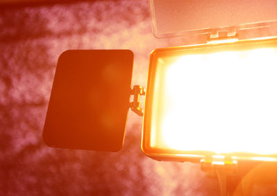 Close-up of illuminated electric lamp on table