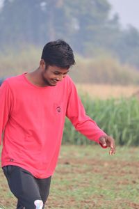 Side view of man standing on field