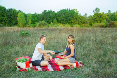 Friends sitting on field