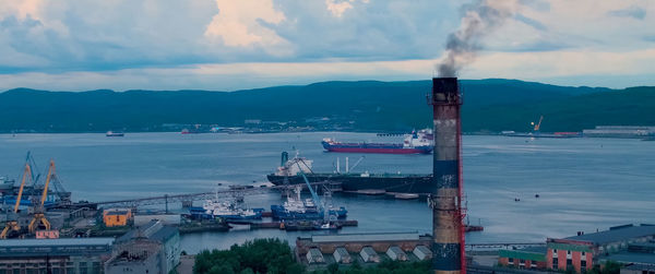 Commercial dock by sea against sky