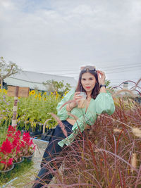 Portrait of young woman sitting on field