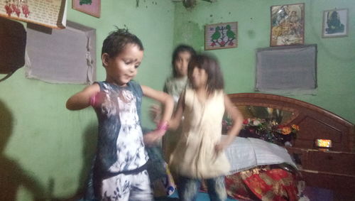 Mother and girl standing at home