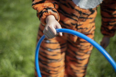 The girl is holding a hoop. the animator plays with the children with a hoop. 