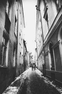 Narrow street leading towards buildings