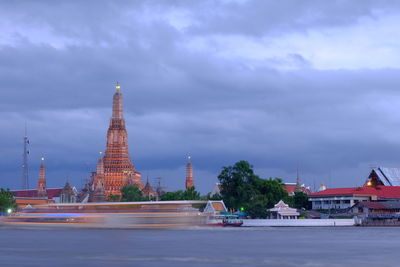 Buildings against cloudy sky