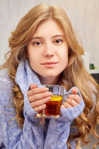 Portrait of young woman drinking glass