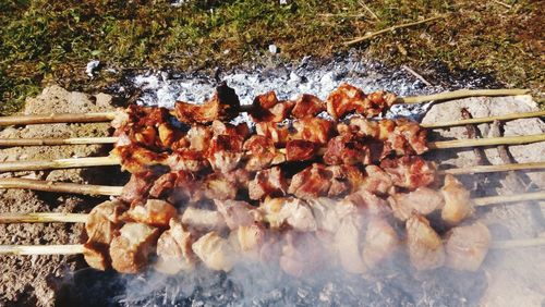 High angle view of meat on barbecue grill