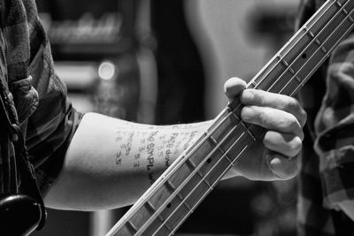 Cropped hand playing guitar