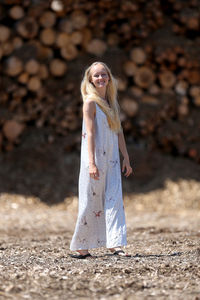 Portrait of a young woman standing on land