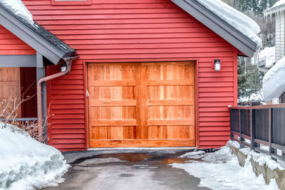 Snow covered wooden door of building