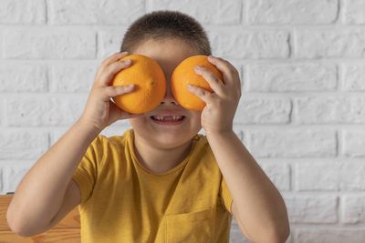 Young woman holding orange fruit