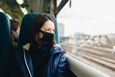 Portrait of young woman in train