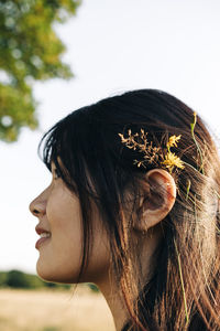 Young woman with grass in hair