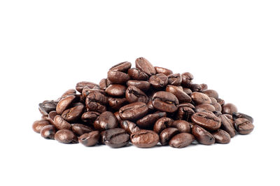 Close-up of coffee beans against white background