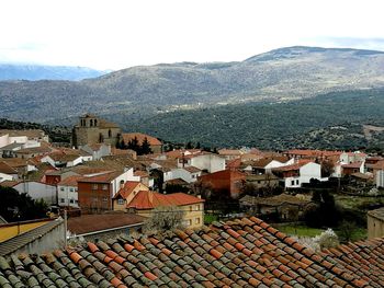 High angle view of houses in town against sky