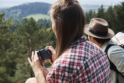 Rear view of woman photographing