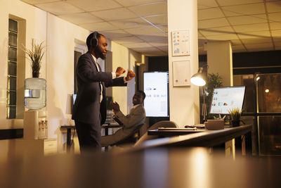 Side view of man using digital tablet in office