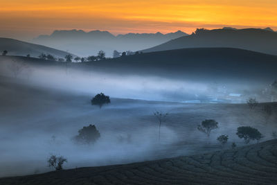 Scenic view of mountains against sky during sunset