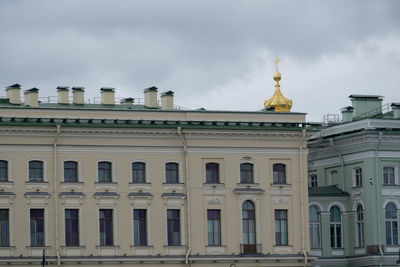 Low angle view of building against cloudy sky