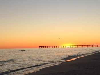 Scenic view of sea against clear sky during sunset