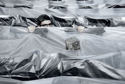 High angle view of man amidst plastic