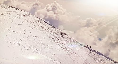 Low angle view of snowcapped mountain against sky