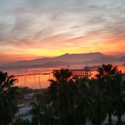 Scenic view of silhouette mountains against sky at sunset