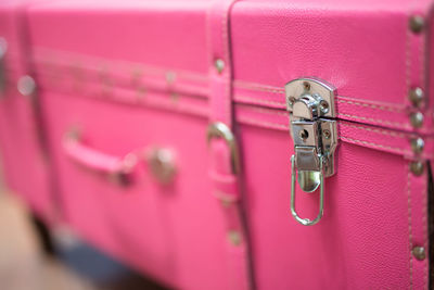 Close-up of pink suitcase