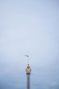 Low angle view of communications tower against sky