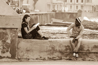 Full length of woman sitting outdoors