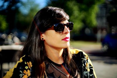 Woman wearing sunglasses standing outdoors