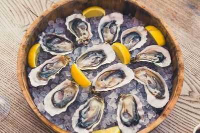 A dozen oysters on ice with lemon, seafood aphrodisiac