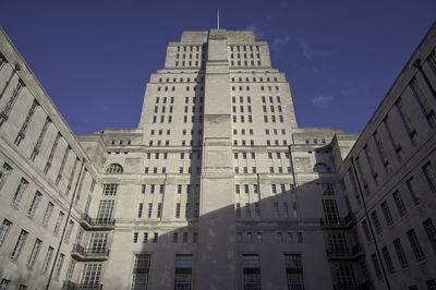 Low angle view of buildings against blue sky