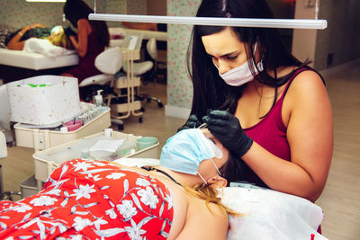 Woman working on customer at spa